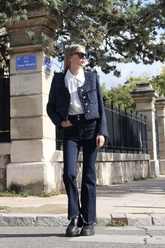 a lady in a white shirt, a sequin tweed jacket and a pair of black pants